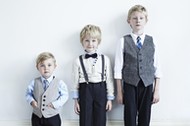 Brothers wearing suits indoors