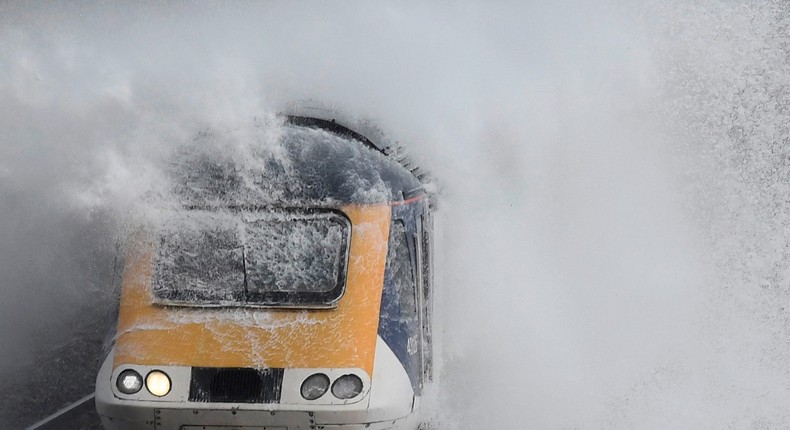 Waves hit a train during heavy seas and high winds in Dawlish in southwest Britain.