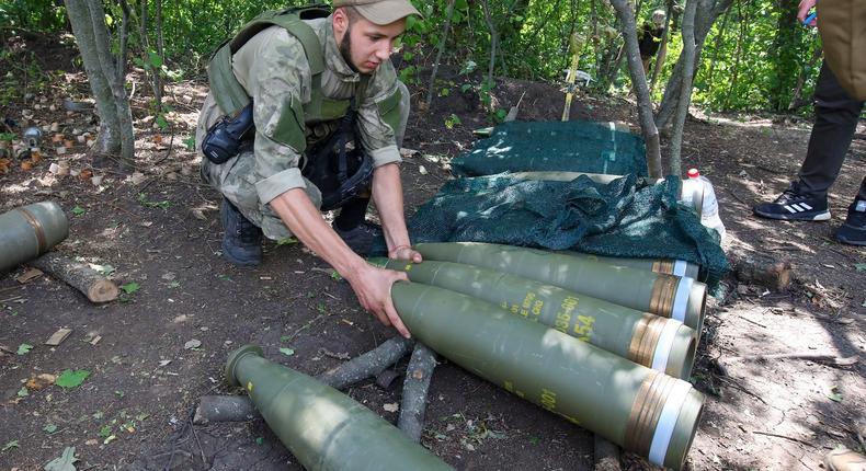 A Ukrainian serviceman with M975 howitzer rounds in the Kharkiv Region on July 28.