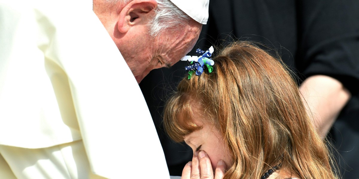 Elizabeth 'Lizzy' Myers who suffers from a genetic disease known as Usher syndrome sits as Pope Francis leads the weekly audience in Saint Peter's Square at the Vatican