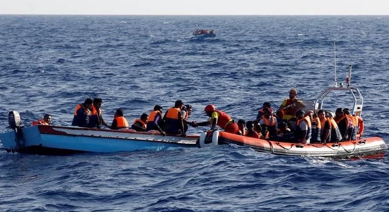 An inflatable boat from the Spanish vessel Astral operated by the NGO Proactiva collects migrants off the Libyan coast in the Mediterranean Sea August 18, 2016. 