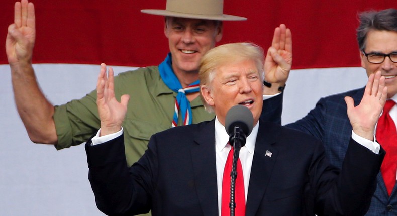 President Donald Trump, front left, gestures as former boys scouts, Interior Secretary Ryan Zinke, left, Energy Secretary Rick Perry, watch at the 2017 National Boy Scout Jamboree at the Summit in Glen Jean,W. Va., Monday, July 24, 2017.