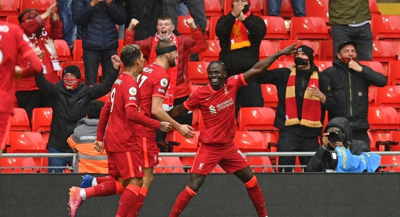 Pointing towards the Champions League: Sadio Mane (right)scored the goals that secured Liverpool a top-four finish