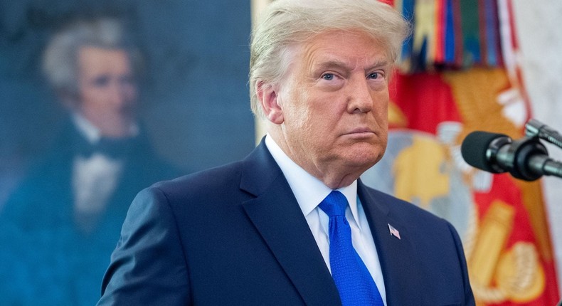 US President Donald Trump looks on during a ceremony presenting the Presidential Medal of Freedom to wrestler Dan Gable in the Oval Office of the White House in Washington, DC on December 7, 2020.