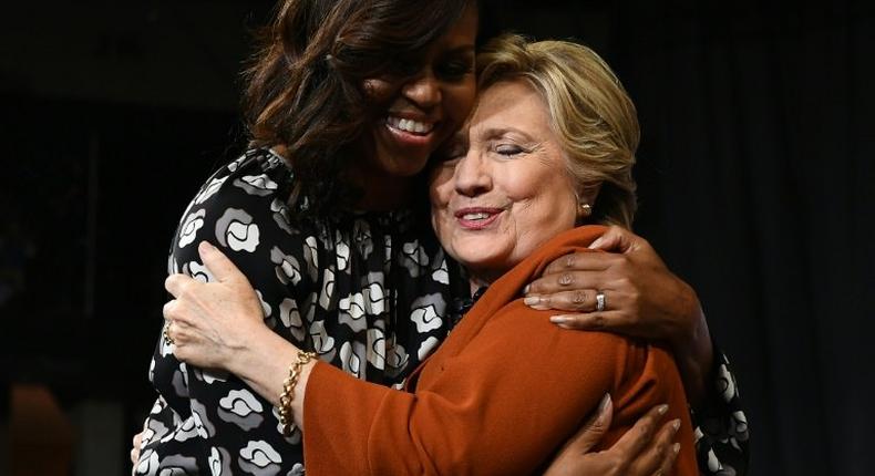 US First Lady Michelle Obama (L) embraces Democratic presidential nominee Hillary Clinton during a campaign rally in Winston-Salem, North Carolina on October 27, 2016