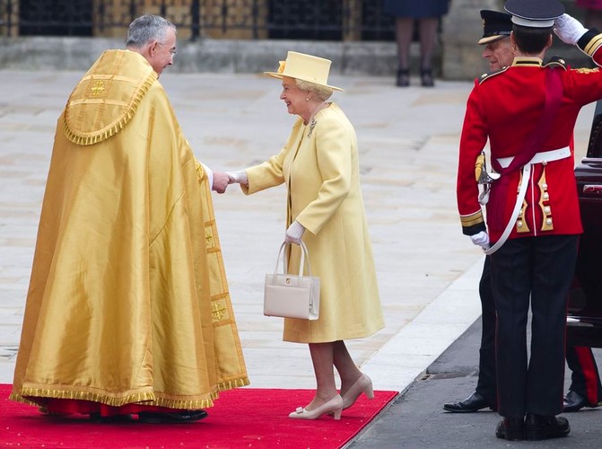 Królowa Elżbieta w kolejnym ze swoich słynnych kapeluszy. Spekulowano, że pokarze się w kolorze kanarkowym, monarchini postawiła jednak na żółć.