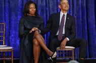 Former U.S. President Obama and first lady Michelle Obama hold hands prior to portraits unveiling at