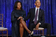 Former U.S. President Obama and first lady Michelle Obama hold hands prior to portraits unveiling at