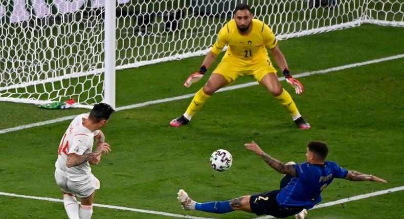 Swiss midfielder Steven Zuber (L) had a shot saved by Gianluigi Donnarumma (C) Creator: Riccardo Antimiani