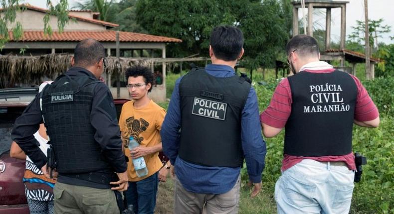 Handout picture released by the Indigenous Missionary Council (CIMI) showing police officers, talking to Gamela indigenous people after a farmers attack in Viana, Maranhao state, north of Brazil on May 1, 2017