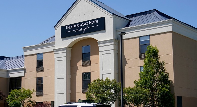 A Town of Newburgh police vehicle is parked outside The Crossroads Hotel where two busloads of migrants arrived hours earlier, Thursday, May 11, 2023, in Newburgh, N.Y. New York City Mayor Eric Adams touched off a furor north of the city by announcing last week that the city would temporarily send north up to 300 single, adult men to two hotels in suburban Rockland County and neighboring Orange County.AP Photo/John Minchillo