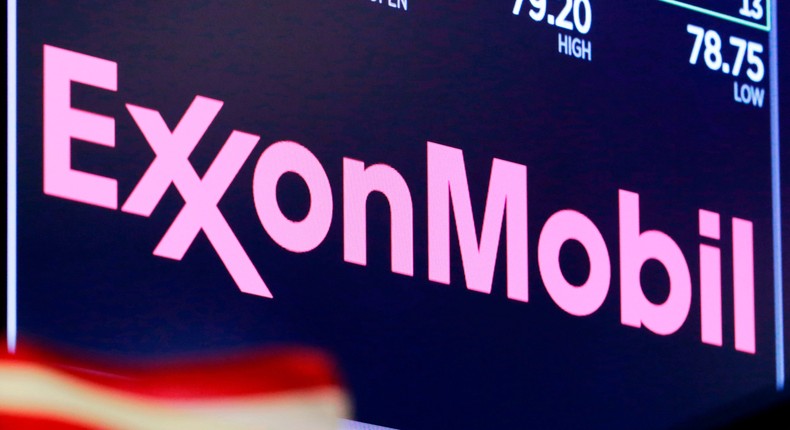 The logo for Exxon Mobil appears above a trading post on the floor of the New York Stock Exchange.