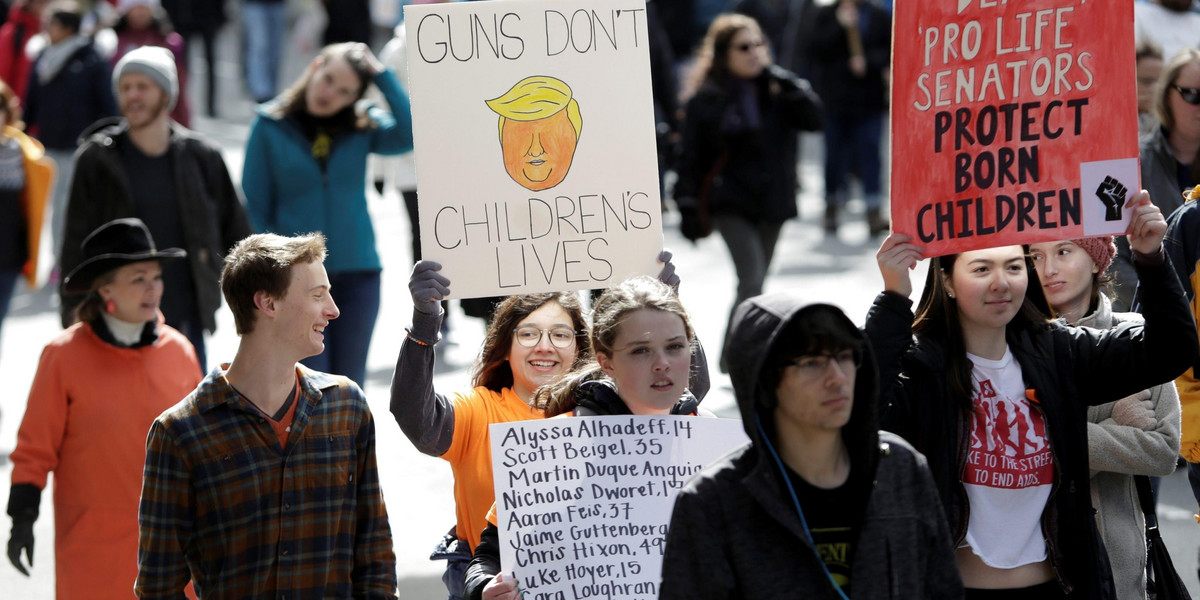 People take part in a "March For Our Lives" demonstration demanding gun control in Seattle