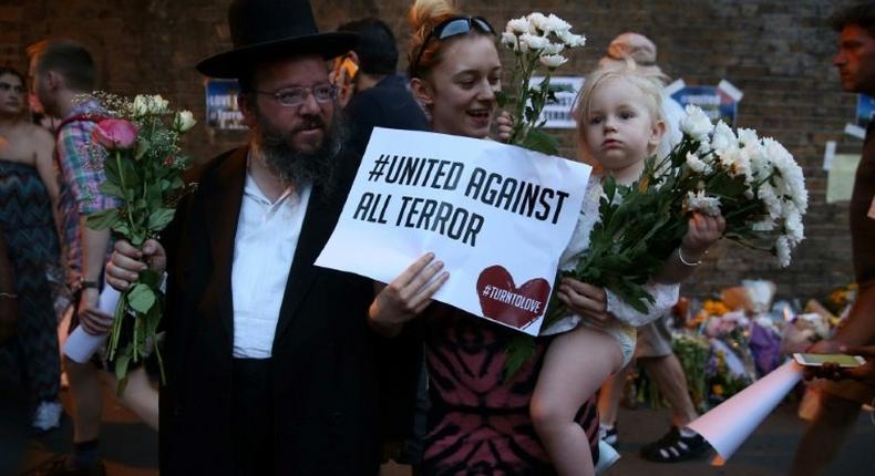 People gather to attend a vigil outside Finsbury Park Mosque, close to the scene of a van attack in Finsbury Park, north London on June 19, 2017