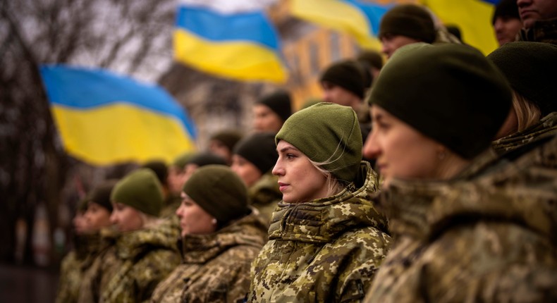 Ukrainian Army soldiers pose for a photo as they gather to celebrate a Day of Unity in Odessa, Ukraine, Wednesday, Feb. 16, 2022.