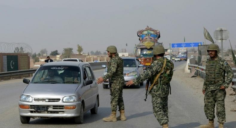 Pakistani paramilitary soldiers stop a vehicle at a security check point in Peshawar on February 17, 2017