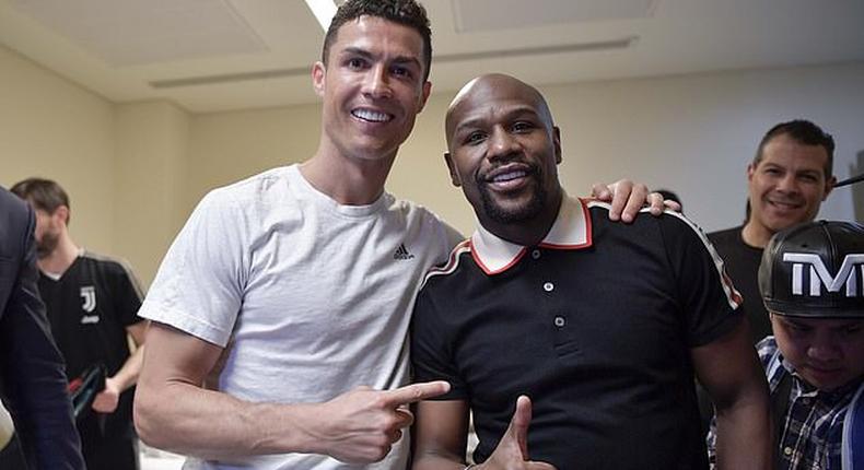 Boxing champion Floyd Mayweather Jr poses with Cristiano Ronaldo