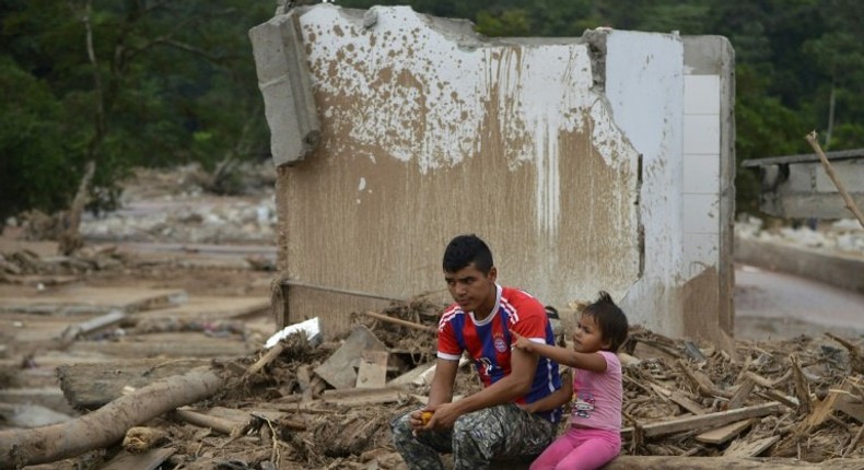 A man and his daughter remain amid rubble in Mocoa, Putumayo department, Colombia on April 4, 2017