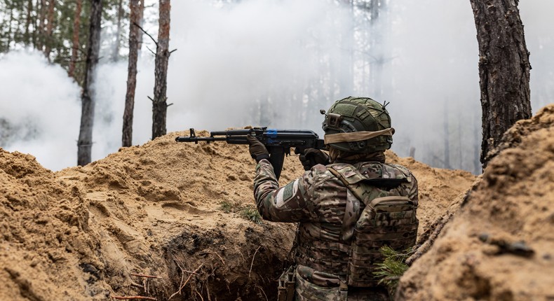 A Ukrainian soldier of the Khartia brigade fires an AK-47 pellet gun from a trench during a training as the Russia-Ukraine war continues in Donetsk oblast, Ukraine, on February 7, 2024.Diego Herrera Carcedo/Anadolu via Getty Images