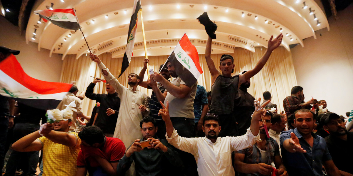 Followers of Iraq's Shiite cleric Muqtada al-Sadr in the parliament building after they stormed Baghdad's Green Zone after lawmakers failed to convene for a vote on overhauling the government in Iraq on April 30.