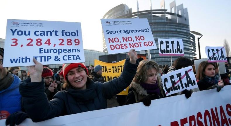 Protestors demonstrate against the EU-Canada trade deal outside the European Parliament in Strasbourg, France