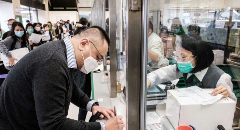 Hong Kongers like Adrian W. Chan (L) are now sending parcels of face masks and other supplies to friends and relatives abroad as the virus spreads