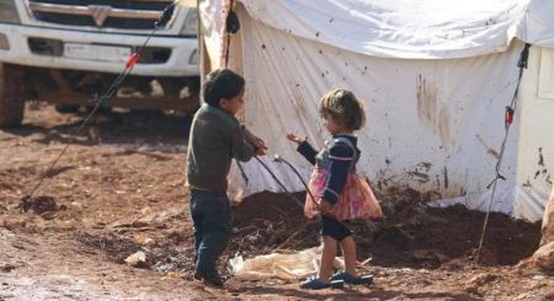 Children play outside tents housing internally displaced people in Atma camp, near the Syrian-Turkish border in Idlib Governorate, February 5, 2016.