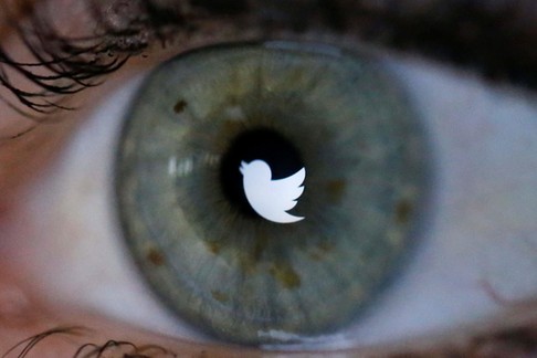 An illustration picture shows the Twitter logo reflected in the eye of a woman in Berlin