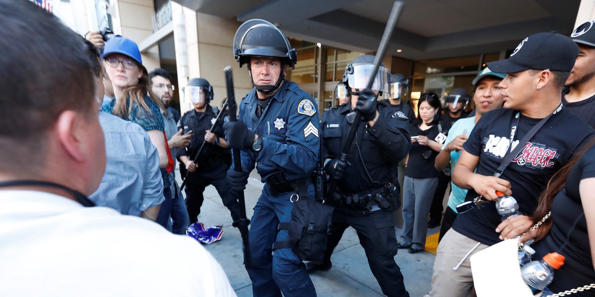 Police officers moved in on a group of protesters after a campaign rally for Republican US presidential candidate Donald Trump in San Jose, California, on Thursday.