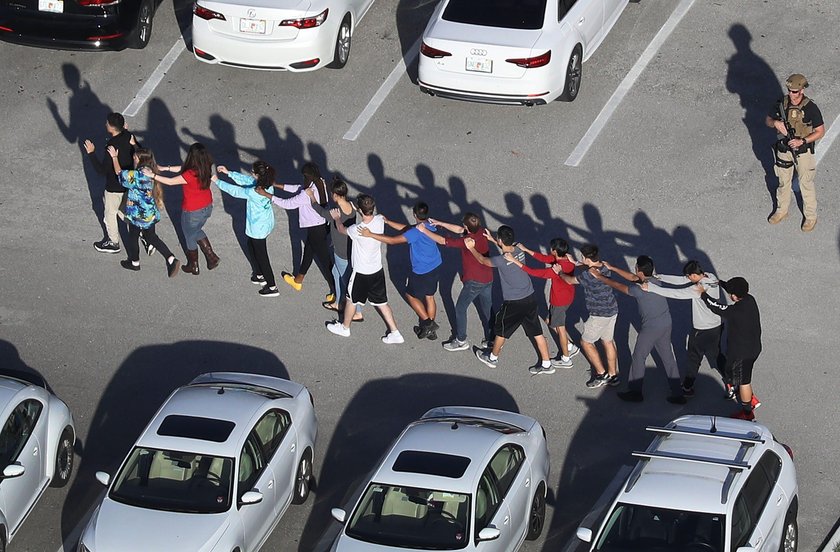 Police escort a suspect into the Broward Jail after checking him at the hospital following a shootin