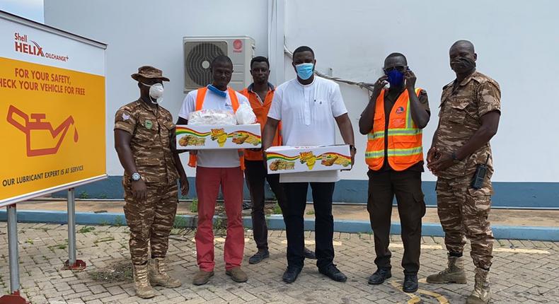 Photos: John Dumelo offers lunch to prisoners weeding on Legon-Shiashie Highway