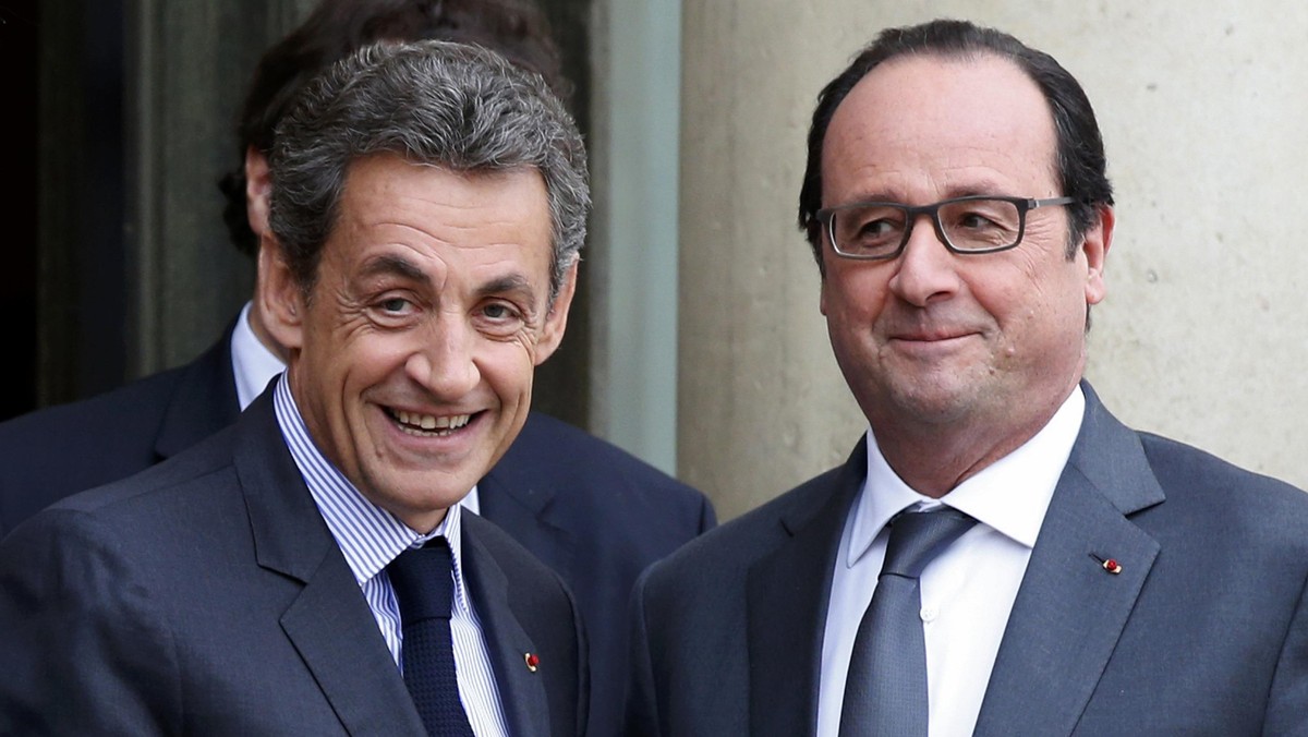 File photo of French President Hollande who stands with Sarkozy, former president and current head of the Les Republicains political party at the Elysee Palace in Paris