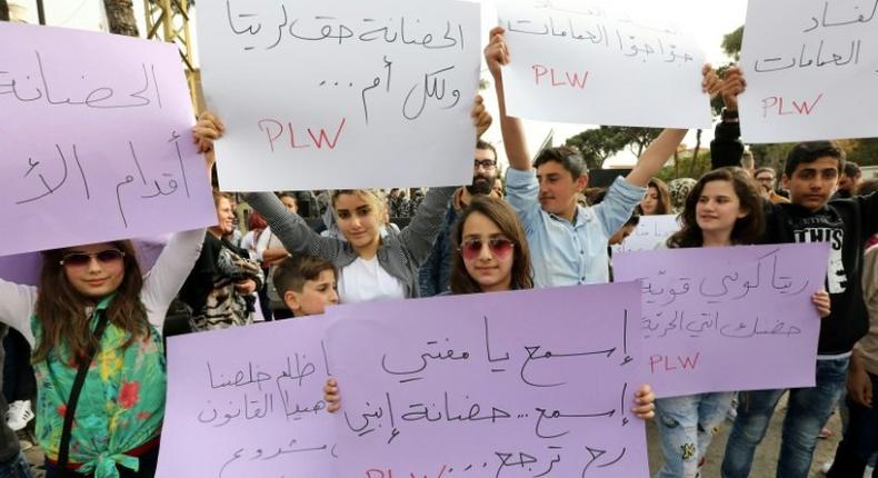 Lebanese protesters rally in front of the Supreme Shiite Council in Beirut to demand clerics increase the age at which the custody of children in divorce cases can be awarded to the mother