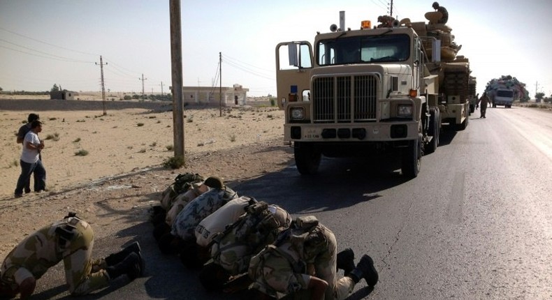 Egyptian soldiers pray as they are deployed in the North Sinai town of El-Arish on July 16, 2013