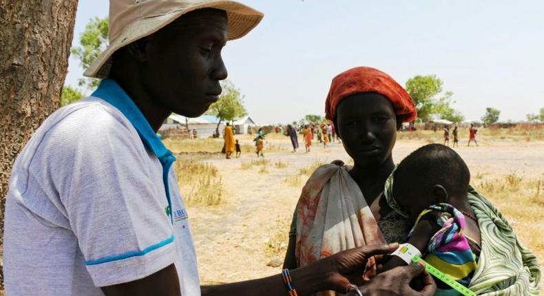 A baby gets a Mid-Upper Arm Circumference (MUAC) test for malnutrition in Thonyor, Leer County of South Sudan