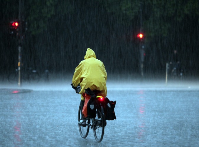 Niezrażony silnymi opadami rowerzysta, sfotografowany w Berlinie