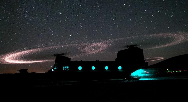 Dust lights up the rotors of a CH-47 Chinook helicopter as US Army paratroopers load for an air-assault mission near Combat Outpost Ab Band, in Ghazni Province, Afghanistan, May 23, 2012.