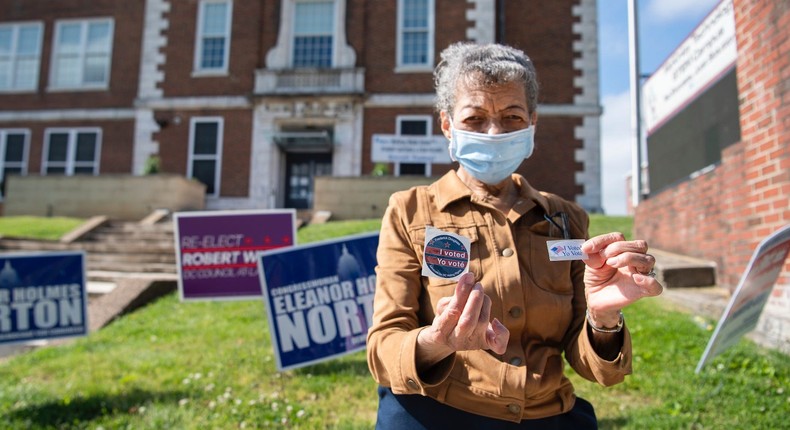 Helen T. Crosson, 84, displays her I Voted sticker after voting early for the June 2nd primary at McKinley Technology High School in Ward 5s Eckington neighborhood on Tuesday, May 26, 2020.