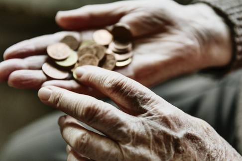 Senior woman's hands with coins