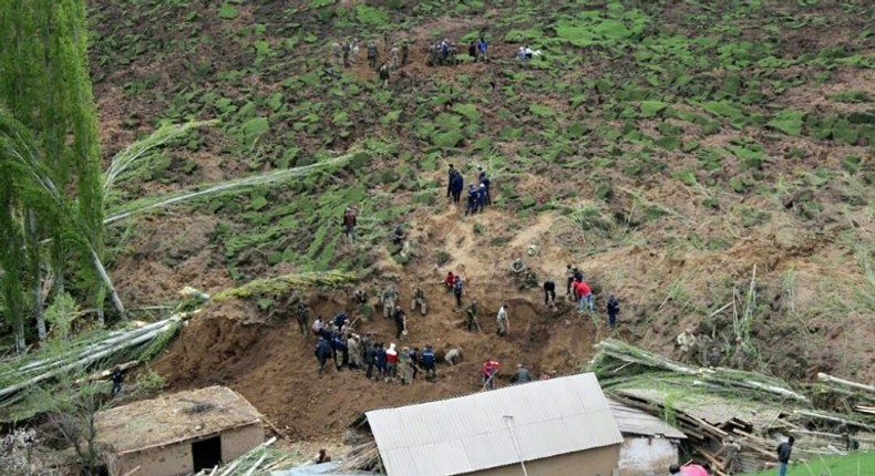 A handout picture taken on April 29, 2017 and provided by the Kyrgyz Red Crescent Society press service shows rescue workers and soldiers working at the site of a landslide in the village of Ayu in Kyrgyzstan's Osh region