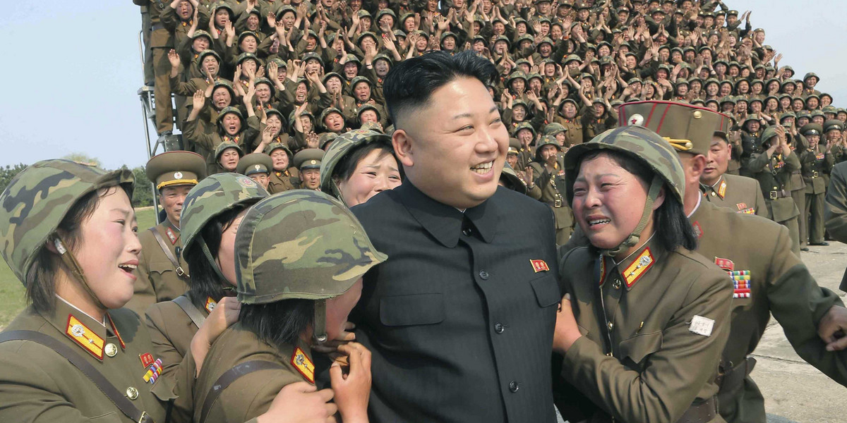 North Korean Supreme Leader Kim Jong Un greets a women's subunit during a rocket-launching drill.