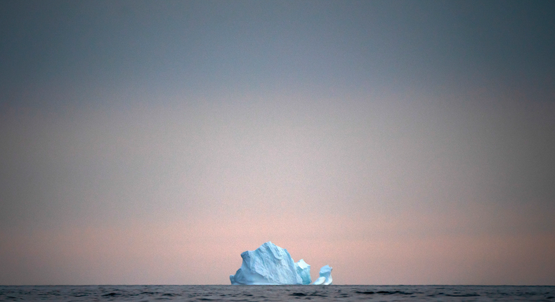 FILE - In this Aug. 15, 2019, file photo, a large Iceberg floats away as the sun sets near Kulusuk, Greenland. As warmer temperatures cause the ice to retreat the Arctic region is taking on new geopolitical and economic importance, and not just the United States hopes to stake a claim, with Russia, China and others all wanting in. (AP Photo/Felipe Dana, File)