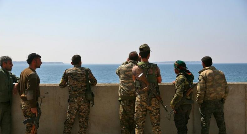 Members of the US-backed Syrian Democratic Forces stand on the Tabqa dam partially recaptured during their drive on the Islamic State group's stronghold in nearby Raqa