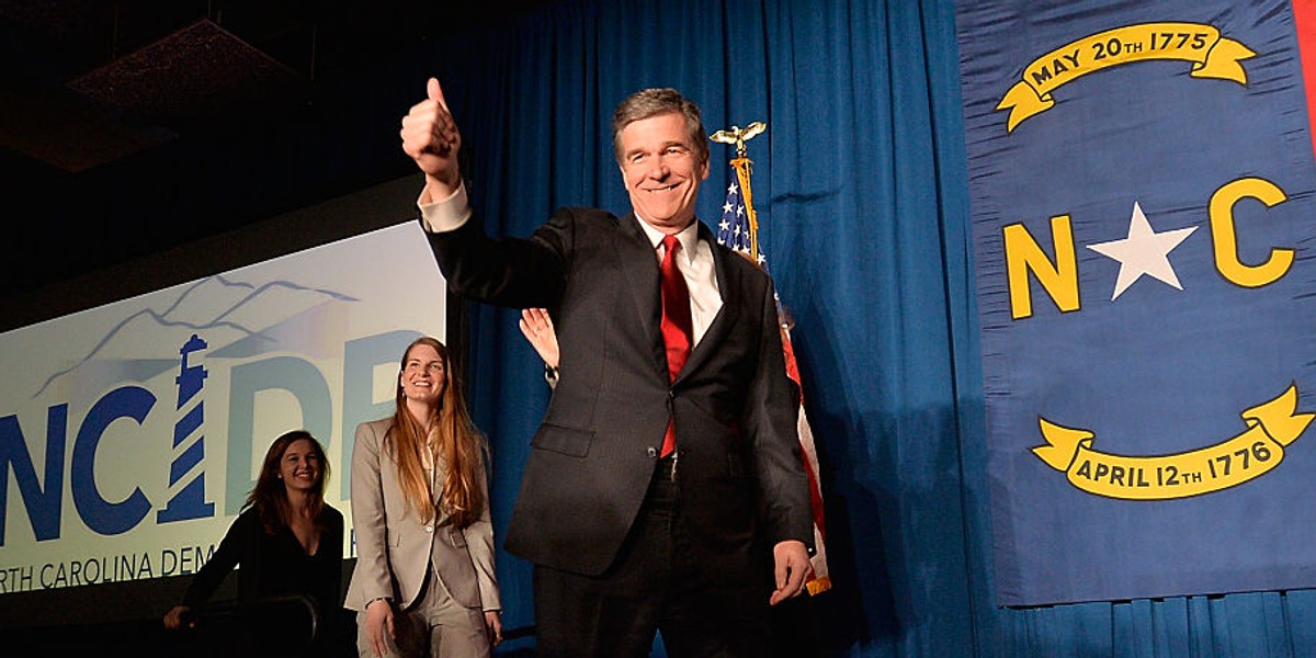 North Carolina Democratic presumptive Governor elect Roy Cooper waves to a crowd at the North Carolina Democratic Watch Party as he walks on stage with his family on November 9, 2016 in Raleigh, North Carolina.