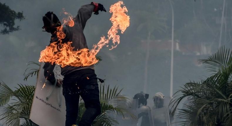 A Venezuelan opposition activist clashes with riot police during a demonstration in Caracas, on June 19, 2017