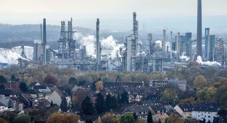 Steam from a BP oil refinery rises behind homes in Gelsenkirchen, Germany.