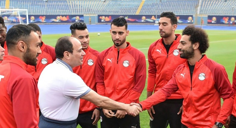 President Abdel Fattah al-Sisi of Egypt greets Liverpool star Mohamed Salah during a visit to the national squad in Cairo ahead of the Africa Cup of Nations in the country. Credit: AFP Photo/HO/Egyptian Presidency