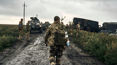 Ukrainian soldiers stand on the road in the freed territory of the Kharkiv region, Ukraine, Monday, Sept. 12, 2022.