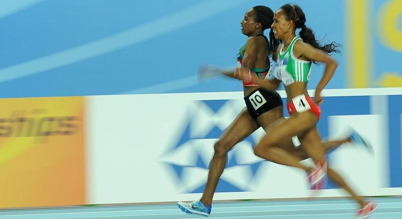 Kenya's Hellen Obiri (R) and Ethiopia's Meseret Defar (R) race at the front in the women's 3000m final at the 2012 IAAF World Indoor Athletics Championships at the Atakoy Athletics Arena in Istanbul on March 11, 2012. (Photo by ADRIAN DENNIS/AFP via Getty Images)