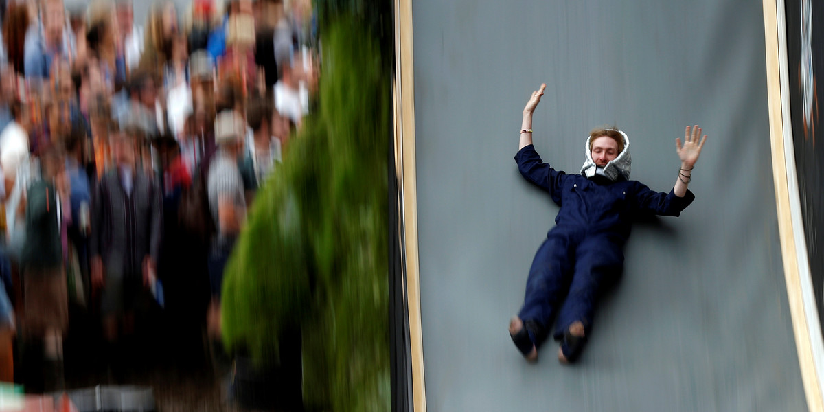 A reveller drops down a slide during the Glastonbury Festival at Worthy Farm in Somerset, Britain June 23, 2016.
